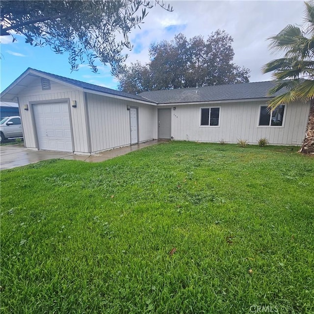 ranch-style home featuring a garage, driveway, and a front lawn