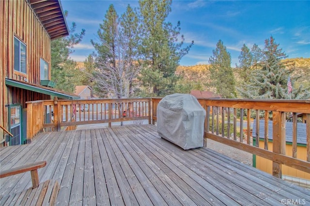 wooden terrace featuring grilling area