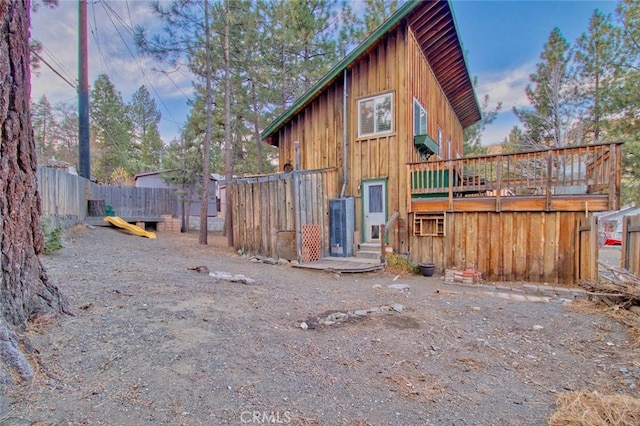 view of property exterior with a wooden deck