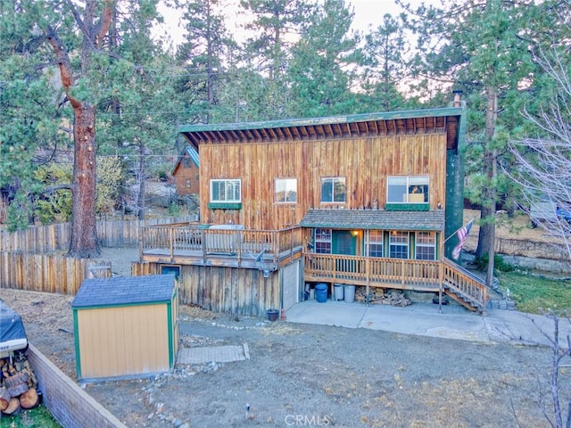 view of front facade with a storage unit and a wooden deck