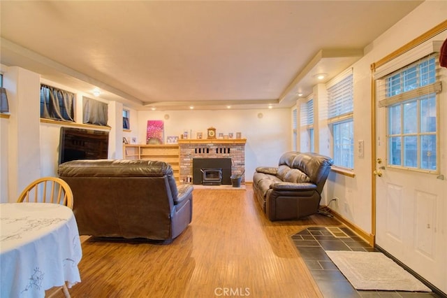 living room with hardwood / wood-style floors and a wood stove