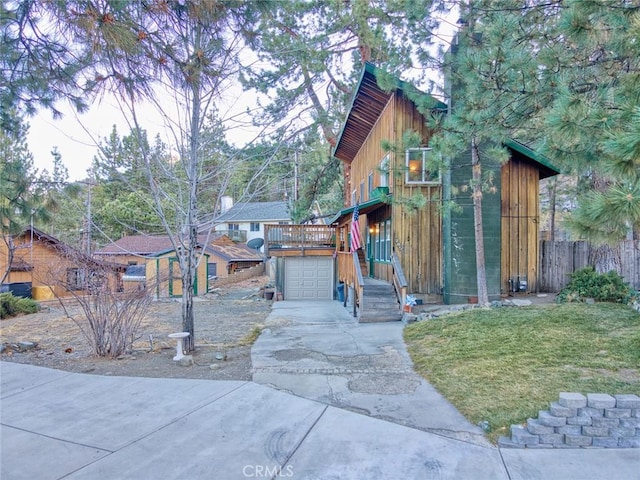 view of front of property with a wooden deck and a garage