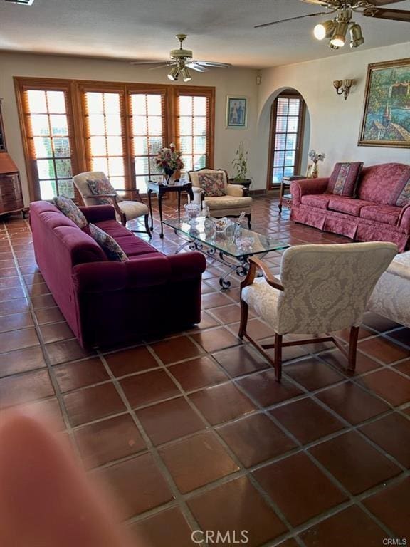 tiled living room featuring ceiling fan