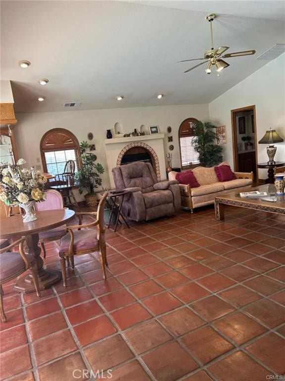 tiled living room with vaulted ceiling and ceiling fan