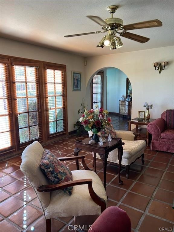 living room with tile patterned floors, plenty of natural light, and ceiling fan