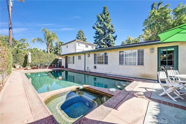 view of swimming pool with an in ground hot tub and a patio area