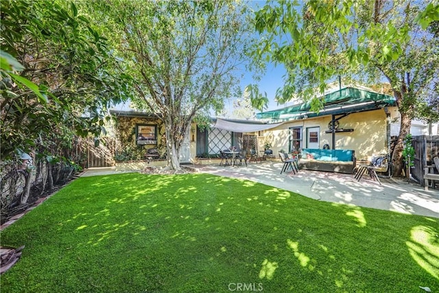 rear view of house featuring a yard, an outdoor hangout area, and a patio