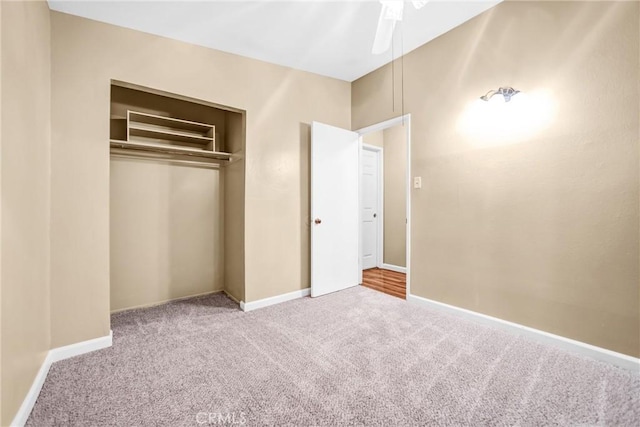 unfurnished bedroom featuring carpet, ceiling fan, and a closet