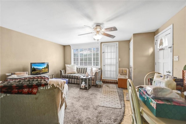 living room featuring ceiling fan and tile patterned flooring