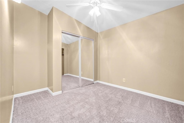 unfurnished bedroom featuring carpet, ceiling fan, and a closet