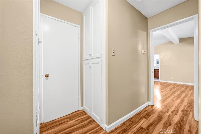 corridor with light hardwood / wood-style floors