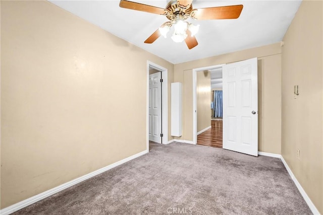 unfurnished bedroom featuring ceiling fan and carpet flooring