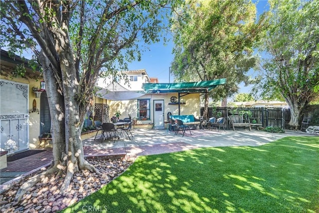 back of property featuring a patio and a lawn