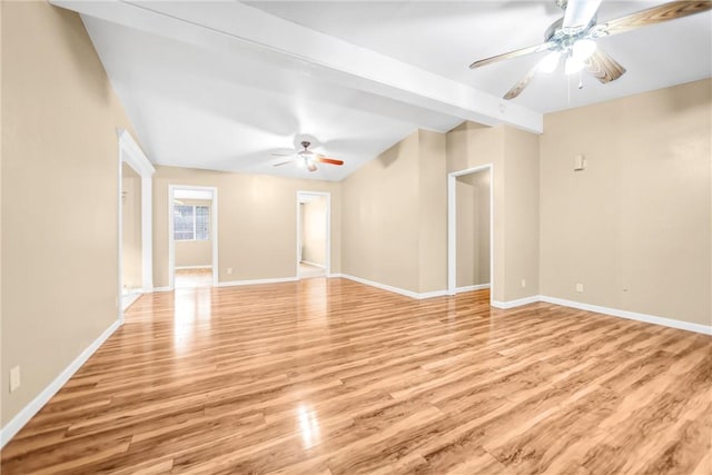 empty room with beamed ceiling, ceiling fan, and light hardwood / wood-style flooring