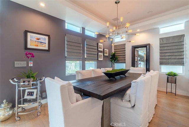 dining area featuring a chandelier and light hardwood / wood-style flooring