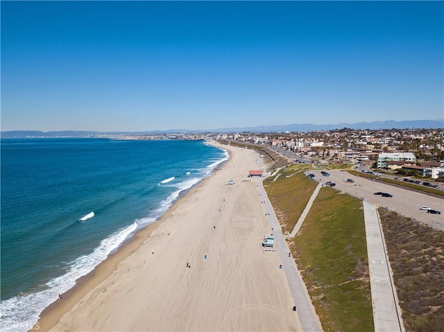 bird's eye view featuring a water view and a beach view