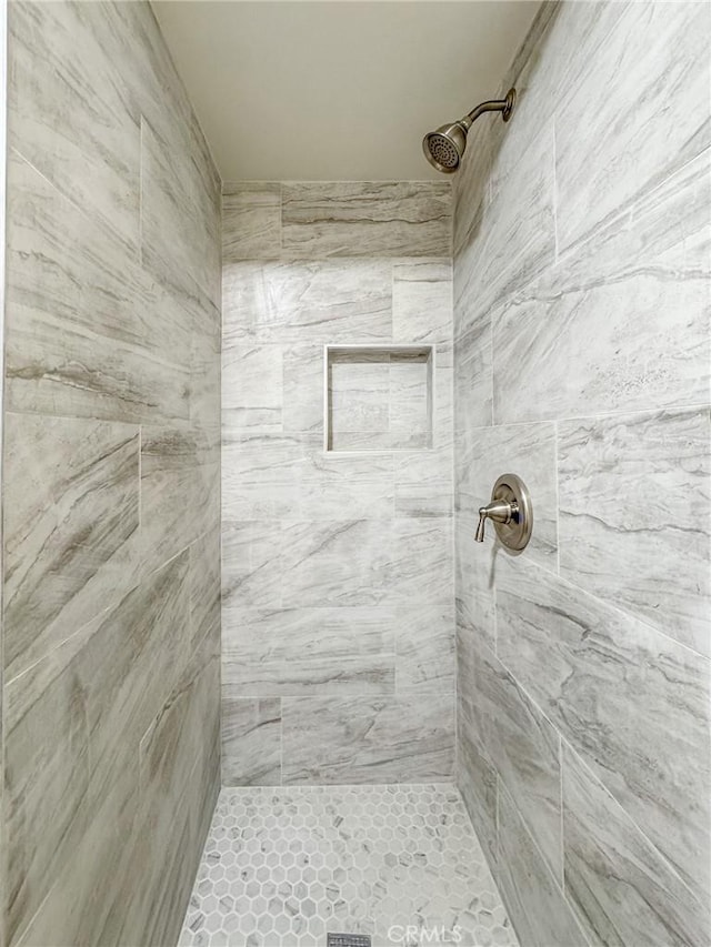 bathroom with tiled shower