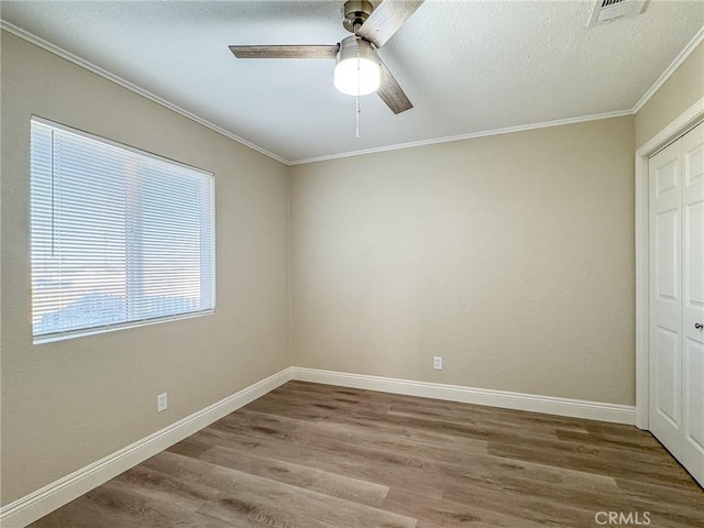 unfurnished bedroom with wood-type flooring, a closet, and ceiling fan