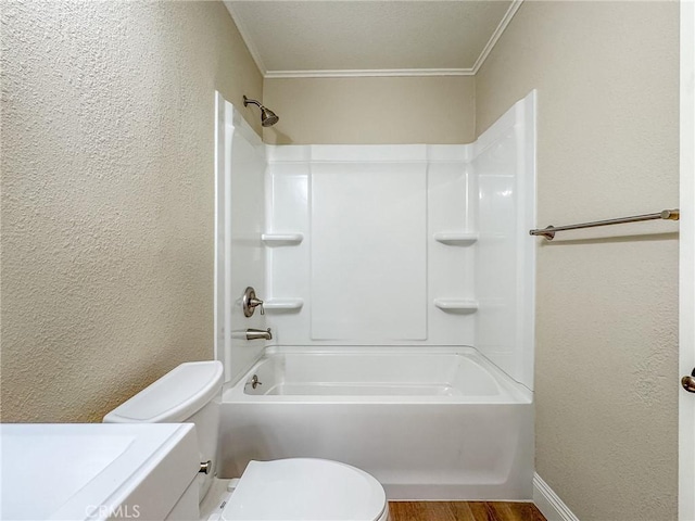 full bathroom with ornamental molding, vanity, shower / bathing tub combination, hardwood / wood-style floors, and toilet