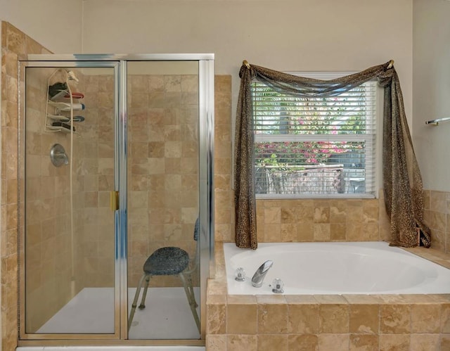 bathroom featuring independent shower and bath