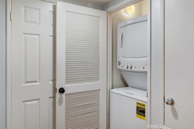 laundry room with stacked washer / drying machine