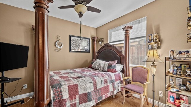 bedroom with ceiling fan and hardwood / wood-style flooring