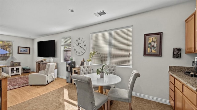 dining area with light tile patterned floors