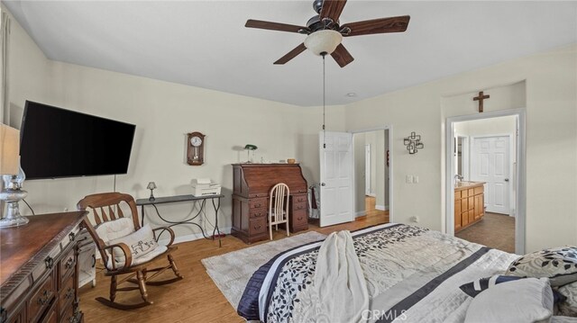 bedroom with ceiling fan, hardwood / wood-style flooring, and ensuite bath