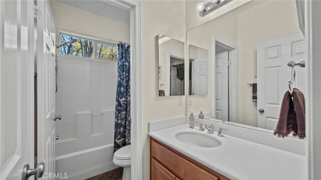 full bathroom featuring toilet, vanity, and shower / tub combo with curtain