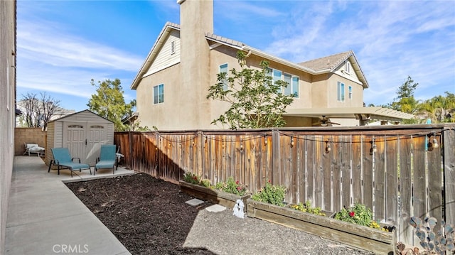 view of yard with a patio area and a storage unit