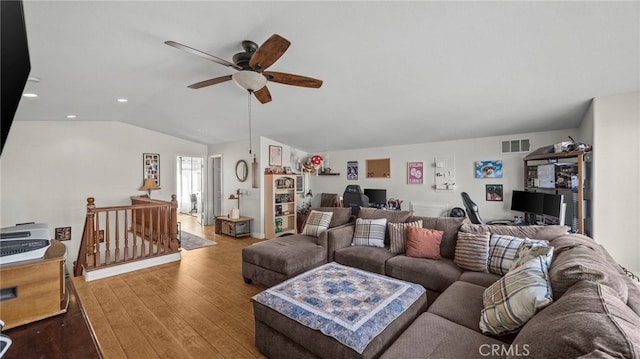 living room with ceiling fan, wood-type flooring, and lofted ceiling