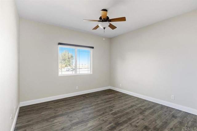 empty room with dark hardwood / wood-style floors and ceiling fan