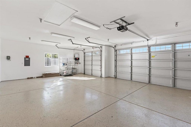 garage with electric panel and a garage door opener