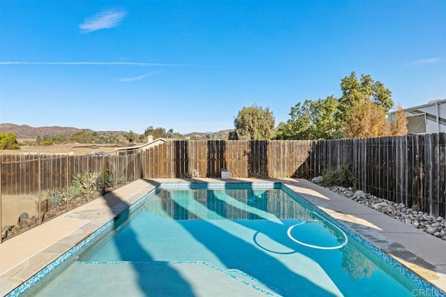 view of swimming pool featuring a mountain view