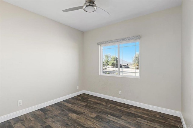 empty room with ceiling fan and dark hardwood / wood-style floors