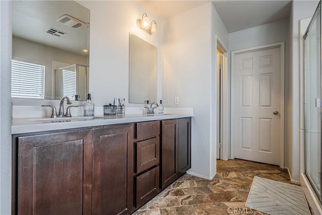 bathroom with walk in shower and vanity