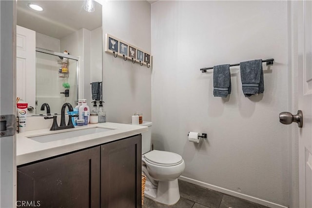 bathroom with tile patterned flooring, toilet, vanity, and a shower with shower door