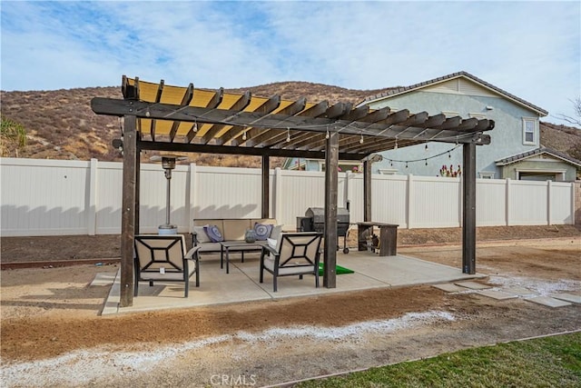 view of patio with an outdoor living space, a mountain view, grilling area, and a pergola