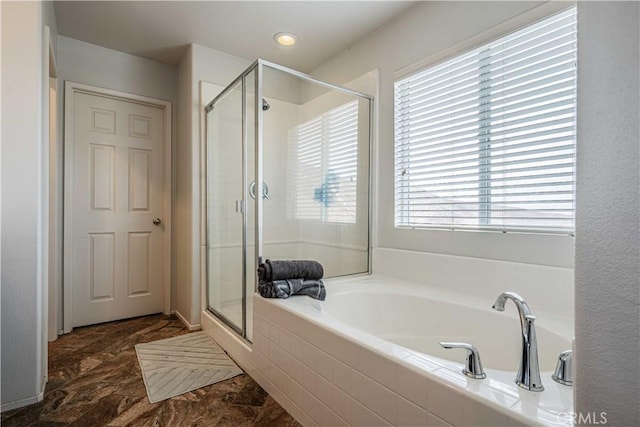 bathroom featuring shower with separate bathtub