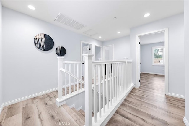 corridor with light hardwood / wood-style flooring