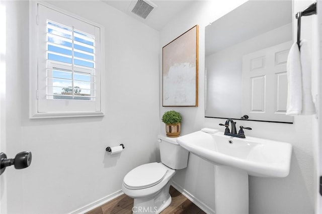 bathroom featuring toilet and hardwood / wood-style flooring