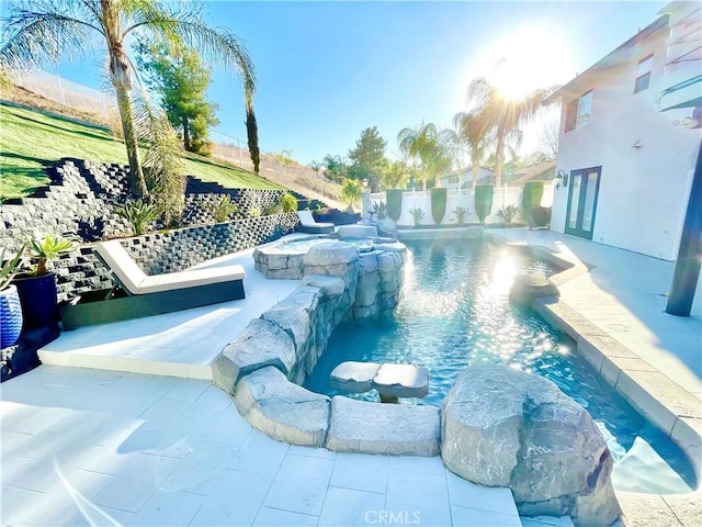 view of pool with pool water feature and an in ground hot tub