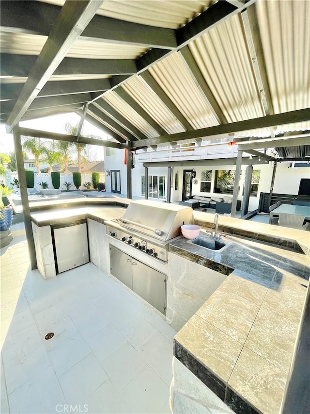 view of patio / terrace featuring a gazebo, an outdoor kitchen, area for grilling, and sink