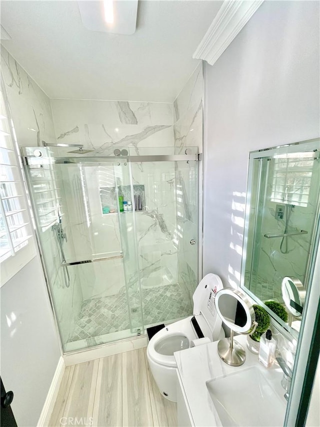 bathroom featuring toilet, vanity, a shower with shower door, and hardwood / wood-style flooring