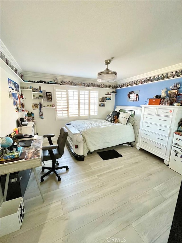 bedroom with light wood-type flooring and ornamental molding