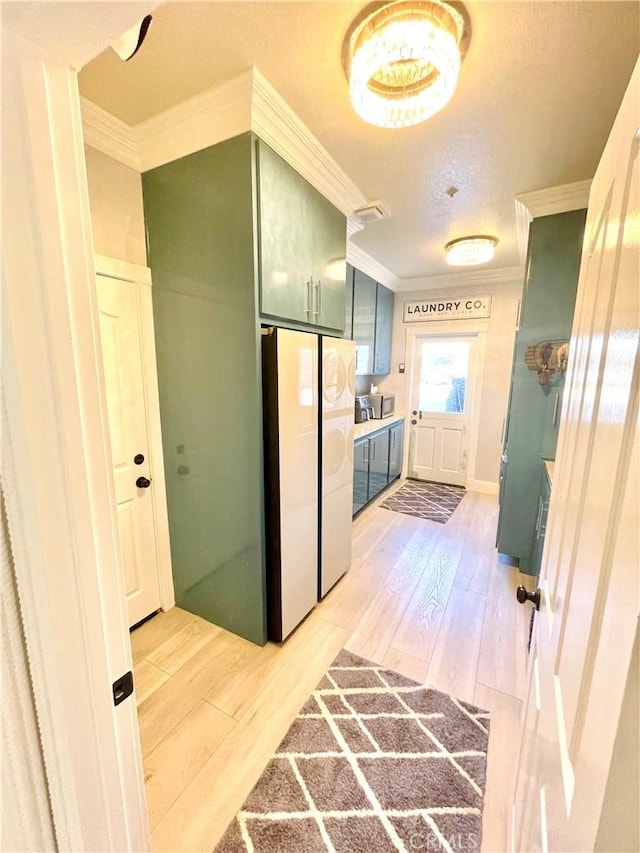 hallway with light wood-type flooring and crown molding