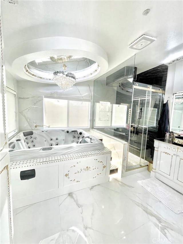 bathroom featuring separate shower and tub, vanity, and an inviting chandelier