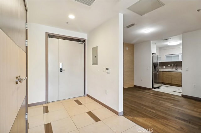 entrance foyer with light wood-type flooring and sink