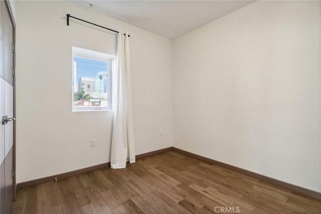 empty room with hardwood / wood-style flooring