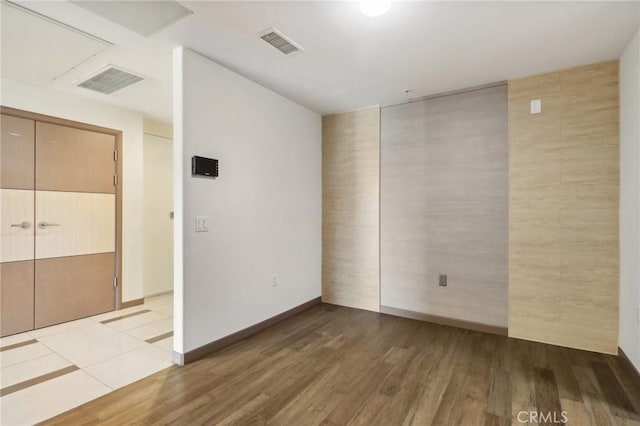 spare room featuring light hardwood / wood-style floors